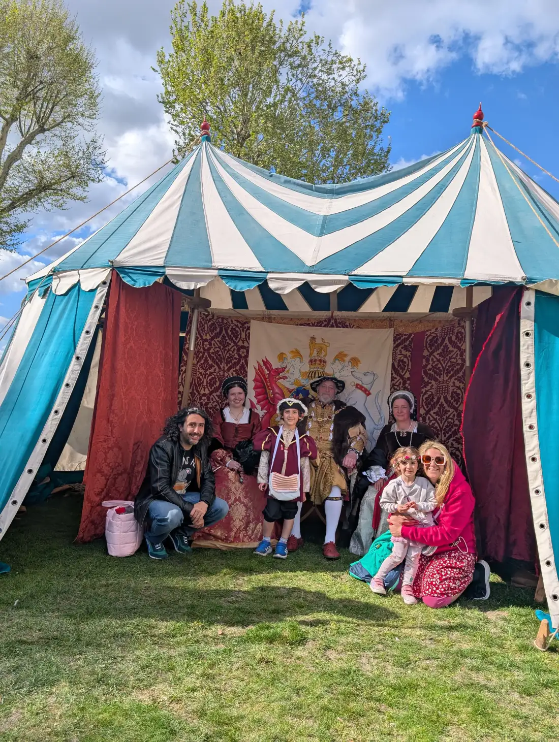 A family posing with Tudor reenactors at a Renaissance fair