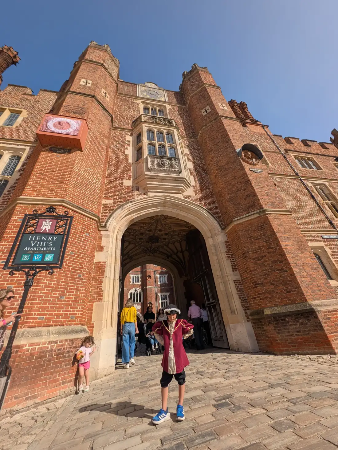 A young visitor in Tudor costume outside Hampton Court Palace